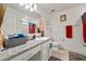 Bathroom with granite countertops, white cabinets, decorative items and neutral-colored walls at 4475 Casablanca Ave, Kissimmee, FL 34746