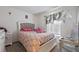 Cozy bedroom with a decorative headboard, patterned bedding, and natural light from the window at 4475 Casablanca Ave, Kissimmee, FL 34746