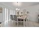 Elegant dining room featuring a modern chandelier, seating for six, and white dining set at 4475 Casablanca Ave, Kissimmee, FL 34746