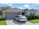 Well maintained home with neat landscaping, two car garage and a car parked in the driveway at 4475 Casablanca Ave, Kissimmee, FL 34746