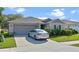 Well maintained home with neat landscaping, two car garage and a car parked in the driveway at 4475 Casablanca Ave, Kissimmee, FL 34746