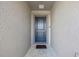 Entryway featuring a solid blue front door, a doormat and neutral-colored stucco walls at 4475 Casablanca Ave, Kissimmee, FL 34746