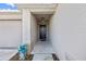 Covered entryway featuring a solid black front door with a Ring doorbell and a doormat at 4475 Casablanca Ave, Kissimmee, FL 34746