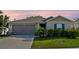 Charming single-Gathering home featuring a well-maintained lawn and an attached two-car garage at 4475 Casablanca Ave, Kissimmee, FL 34746