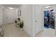 Entryway hallway with tile flooring, leading to a laundry room and the main entrance at 4475 Casablanca Ave, Kissimmee, FL 34746