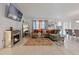 Bright living room with decorative fireplace, comfortable seating, and view to dining area at 4475 Casablanca Ave, Kissimmee, FL 34746