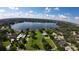 Scenic aerial view of a property with a lake, offering stunning waterfront potential at 4654 Thornlea Rd, Orlando, FL 32817