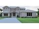 Charming two-story home with a metal roof, a front-facing two car garage, and a well-maintained lawn at 4654 Thornlea Rd, Orlando, FL 32817