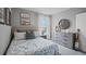 Cozy bedroom with nautical-themed decor, including surfing motifs and soft, inviting bedding at 487 Taylor Groves Dr, Lake Wales, FL 33898