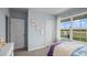 Bright bedroom with a view to the front yard and light blue walls at 487 Taylor Groves Dr, Lake Wales, FL 33898