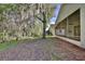 View of the backyard from the side of the house and screened in porch at 604 Coral Trace Blvd, Edgewater, FL 32132