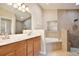 Bathroom features a double vanity, soaking tub, and glass shower at 604 Coral Trace Blvd, Edgewater, FL 32132