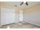 Bright bedroom boasts wood-look floors, a ceiling fan, and closet at 604 Coral Trace Blvd, Edgewater, FL 32132