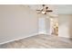 Large bedroom with wood-look floors, a ceiling fan, and access to a walk-in closet at 604 Coral Trace Blvd, Edgewater, FL 32132