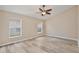 Spacious bedroom features stylish wood-look flooring, a ceiling fan, and plenty of natural light at 604 Coral Trace Blvd, Edgewater, FL 32132