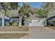 Charming single-story home with a two-car garage and well-maintained landscaping at 604 Coral Trace Blvd, Edgewater, FL 32132