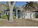 Inviting home exterior featuring lush greenery and an arched entryway at 604 Coral Trace Blvd, Edgewater, FL 32132