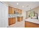 Bright kitchen with ample counter space, wood cabinetry, and a stainless steel microwave at 604 Coral Trace Blvd, Edgewater, FL 32132
