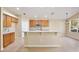 Well-lit kitchen with a breakfast bar, tiled backsplash, and modern appliances at 604 Coral Trace Blvd, Edgewater, FL 32132