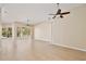 Spacious open-plan living room featuring tile floors and ceiling fans at 604 Coral Trace Blvd, Edgewater, FL 32132