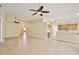 Open-concept living space with tile flooring, connecting the kitchen and living area at 604 Coral Trace Blvd, Edgewater, FL 32132