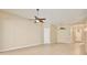 Expansive living room featuring tile flooring and modern ceiling fans at 604 Coral Trace Blvd, Edgewater, FL 32132