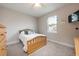 Bright and cozy bedroom with a wooden bed frame and simple decor at 706 Hyperion Dr, Debary, FL 32713