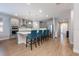 Modern kitchen with stainless steel appliances, a large island, and stylish blue chairs at 706 Hyperion Dr, Debary, FL 32713