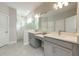Elegant main bathroom with double vanity, modern fixtures, and a sleek glass-enclosed shower at 706 Hyperion Dr, Debary, FL 32713