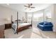 Inviting main bedroom with a four-poster bed, sitting area, and ample natural light at 706 Hyperion Dr, Debary, FL 32713