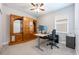 Bright office with a large wooden storage unit, desk, and comfortable office chair at 706 Hyperion Dr, Debary, FL 32713