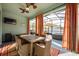 Covered patio with dining table, chairs, and a view of the backyard spa at 706 Hyperion Dr, Debary, FL 32713
