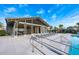 Resort-style community pool with lounge chairs, a covered area, and lush landscaping at 706 Hyperion Dr, Debary, FL 32713