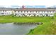 Scenic aerial view of townhomes backing up to a tranquil pond offering a serene and private setting at 730 Longboat Dr, Davenport, FL 33896