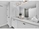 Bathroom featuring double sink vanity with white cabinets and quartz countertop at 730 Longboat Dr, Davenport, FL 33896