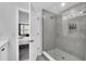 Modern bathroom boasts a glass-enclosed shower with gray tiling and adjacent bedroom at 730 Longboat Dr, Davenport, FL 33896