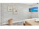A bedroom displays stylish wallpaper, framed art, and an entertainment center wall-mounted TV at 730 Longboat Dr, Davenport, FL 33896