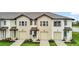 Inviting two-story townhome with a well-manicured lawn, offering curb appeal and comfortable Gathering living at 730 Longboat Dr, Davenport, FL 33896
