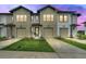 Charming townhomes featuring attached garages, modern architecture, and landscaped front yards at 730 Longboat Dr, Davenport, FL 33896