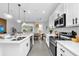 Contemporary kitchen with stainless steel appliances, an island with pendant lights, and open layout to living areas at 730 Longboat Dr, Davenport, FL 33896