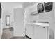 Well-equipped laundry room boasts modern washer and dryer, and a spacious storage shelf at 730 Longboat Dr, Davenport, FL 33896