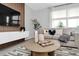 Cozy living room with modern decor, comfortable seating, and large window at 730 Longboat Dr, Davenport, FL 33896