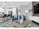 Bright open-concept living area with modern furnishings, and a view of the kitchen and entryway at 730 Longboat Dr, Davenport, FL 33896