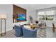 Inviting living room with a modern media wall, stylish furnishings, and a light grey color palette at 730 Longboat Dr, Davenport, FL 33896