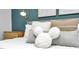 Close up of bed with decorative Mickey Mouse pillow and side table at 730 Longboat Dr, Davenport, FL 33896