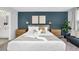 Main bedroom featuring blue accent wall, decorative pillows, and lots of natural light at 730 Longboat Dr, Davenport, FL 33896