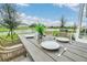 Charming outdoor dining area set with tableware overlooking a serene pond view at 730 Longboat Dr, Davenport, FL 33896