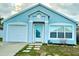 Charming one-story home with a light blue exterior, complemented by a well-manicured lawn and inviting entrance at 743 Belvoir Dr, Davenport, FL 33837