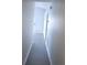 Hallway features streamlined design and neutral color palette, leading to the front door at 743 Belvoir Dr, Davenport, FL 33837