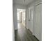 Clean hallway featuring modern flooring and multiple doorways, leading to various rooms in the home at 743 Belvoir Dr, Davenport, FL 33837